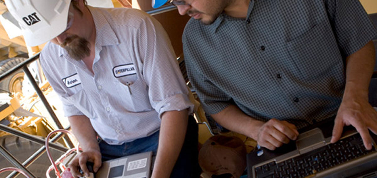 Two men comparing notes at a jobsite
